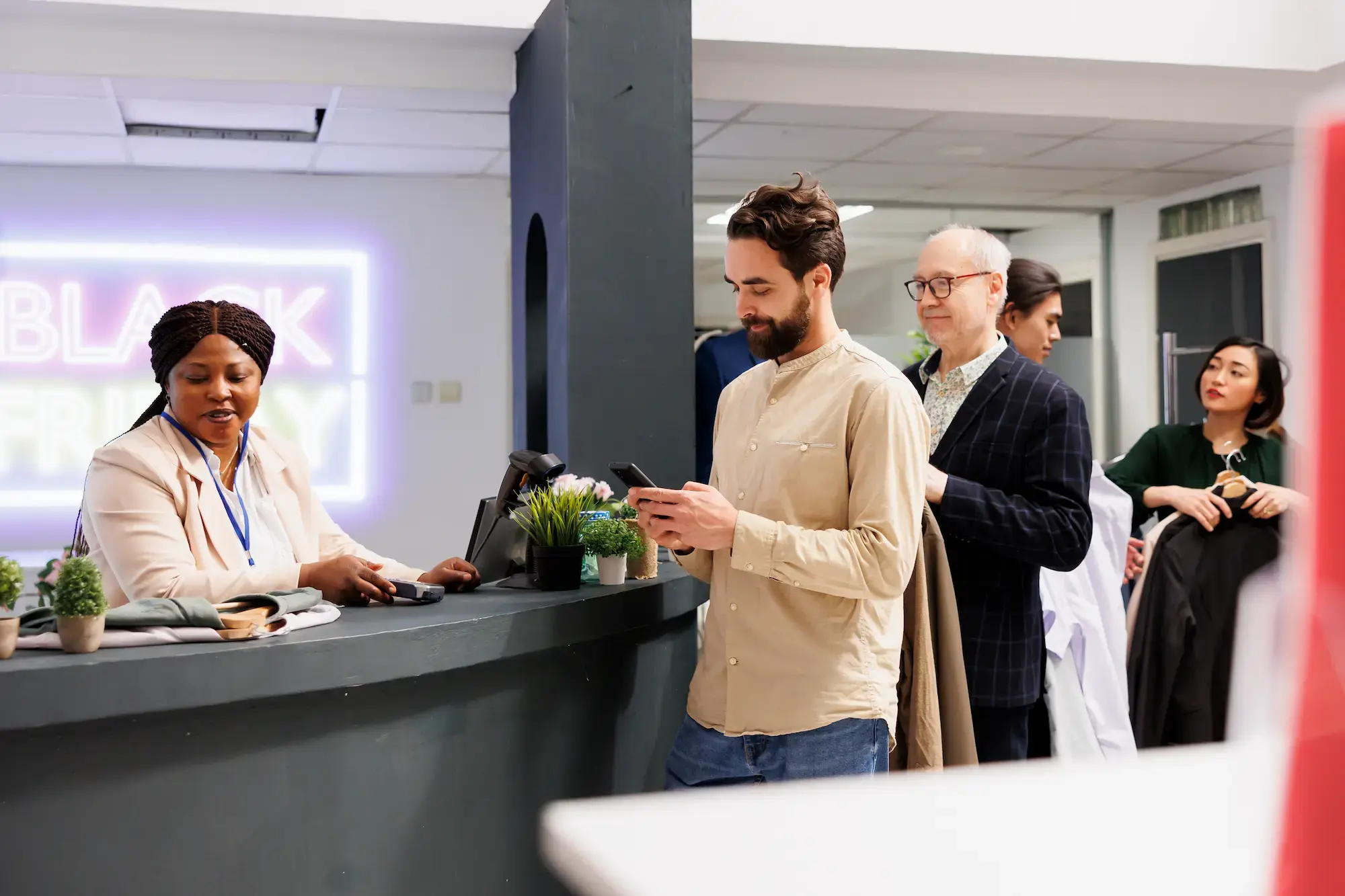 diverse-people-standing-line-with-clothes-hands-while-shopping-black-friday-fashion-store-customers-waiting-payment-cash-register-buying-clothing-items-discounted-prices