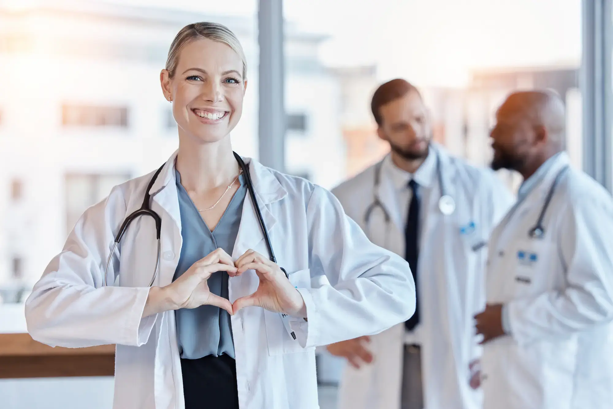 healthcare-heart-hands-with-portrait-doctor-hospital-medical-support-kindness-motivation-wellness-medicine-with-woman-gesture-clinic-cardiology-care-emoji